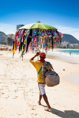 Brazilian street vendor sells swimsuit at Copacabana, Rio de Jan
