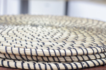 Detail view of several round trivet made of wicker