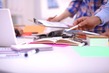 Close-up of three young creative designers working on project