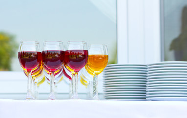 Wedding banquet outdoors. Wedding ceremony. Glasses of red and white wine. Glass of champagne
