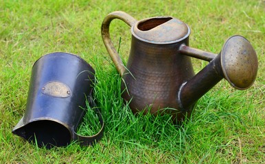 Vintage metal watering cans in the garden
