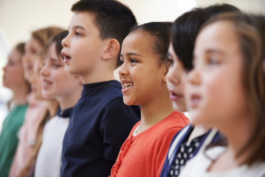 Group Of School Children Singing In Choir Together