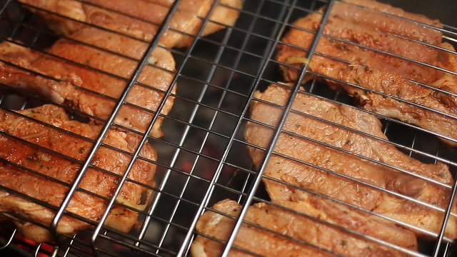 Meat on the grill with flames closeup