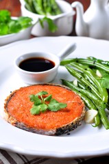 Salmon steak with green beans, garlic, black sesame and soy sauce. Selective focus.