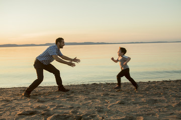 Father with is son at the sunset