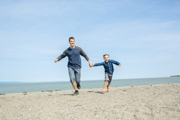 father play son side of the beach