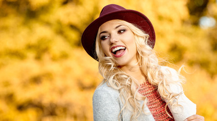 Beautiful elegant woman standing in  autumn park