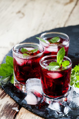Pomegranate drink with mint and ice, selective focus