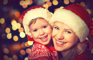 happy family mother and little child playing in Christmas