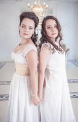 Two beautiful woman in old-fashioned negligee