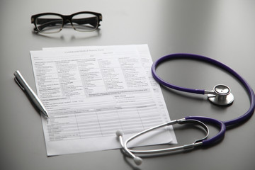 Stethoscope on the grey desk, close up