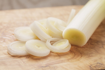 sliced leek on wooden board