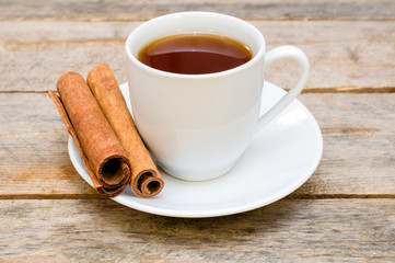 tea with cinnamon on wooden table