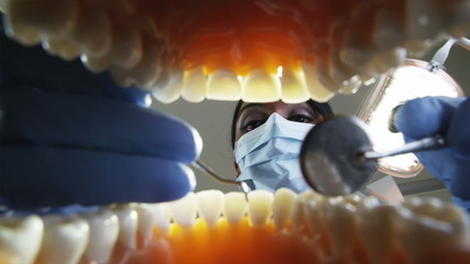 dental hygienist working on a male patient