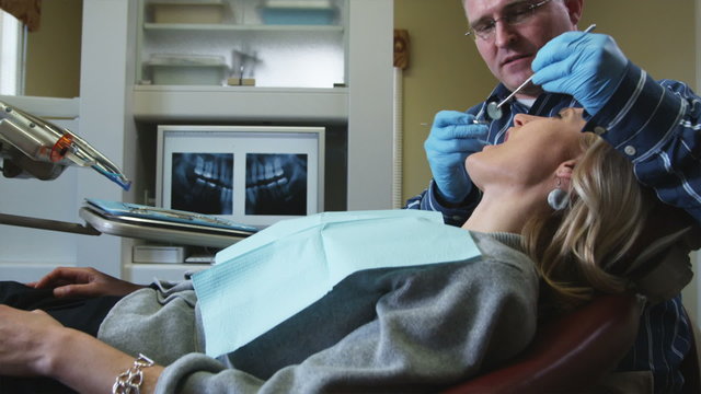 dentist examining a female patient