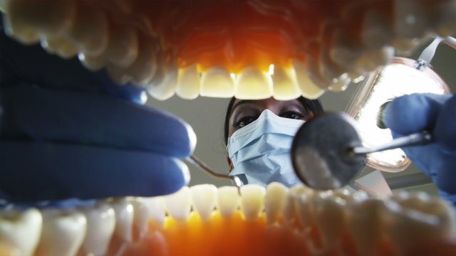 dental hygienist working on a male patient