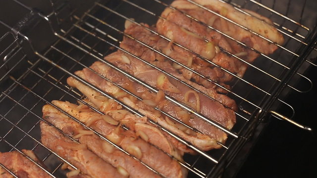 Meat on the grill with flames closeup