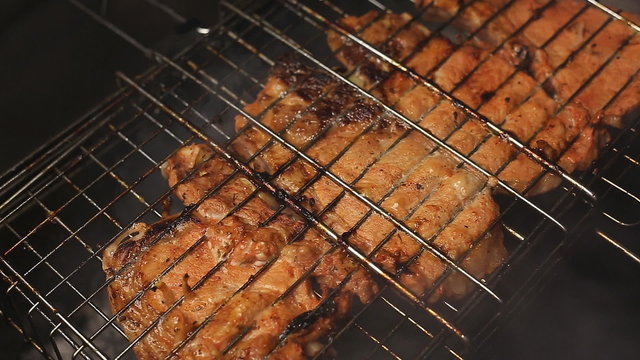 Meat on the grill with flames closeup