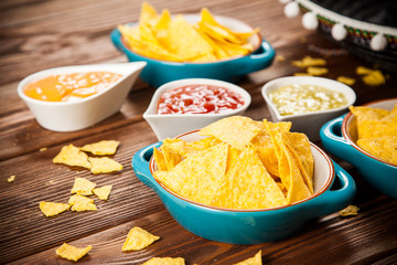 Plate of nachos with different dips