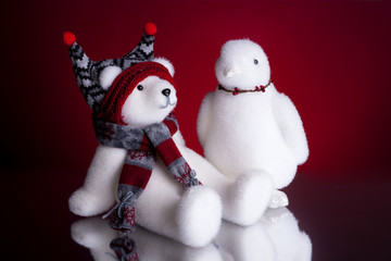 Christmas present with fluffy polar bear and a penguin shot front on on a red background