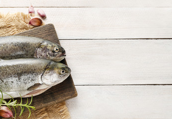 Two rainbow trouts on rustic wooden table