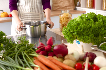 Young Woman Cooking in the kitchen. Healthy Food