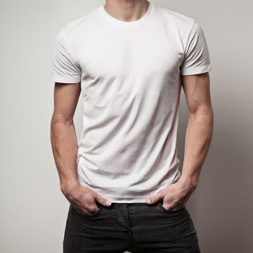 blank white t-shirt on muscle young man and white wall background