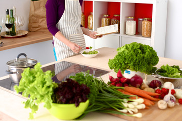 Young Woman Cooking in the kitchen. Healthy Food