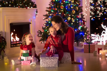 Mother and children at home on Christmas eve