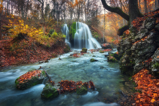 Fototapeta Beautiful waterfall in autumn forest in crimean mountains at sun