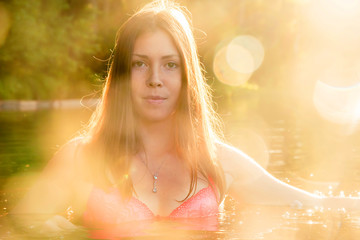 Beautiful naked woman in lake at the summer sunny day