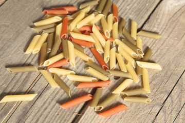 Raw homemade pasta and ingredients for pasta on wooden