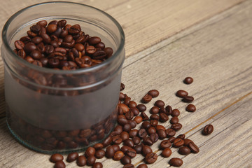 coffee beans in a glass jar on a wooden table