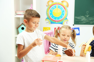 Cute children at lunch time in classroom