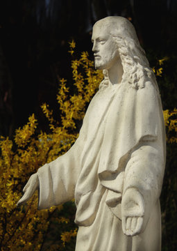 Jesus Christ statue against a dark background