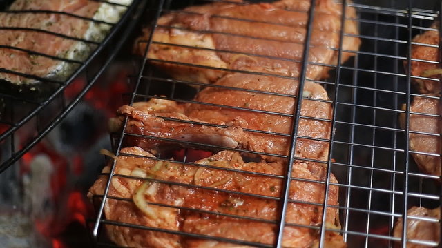 Meat on the grill with flames closeup