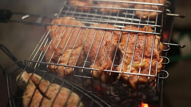 Meat on the grill with flames closeup