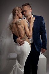 Beautiful wedding couple posing in studio.