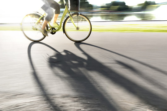 Fototapeta Person on bike casting shadow