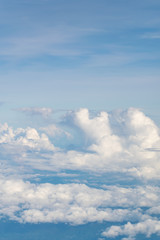 Blue sky and clouds. view from the window of an airplane flying in the clouds