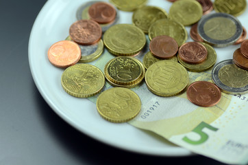 Münzen auf Teller