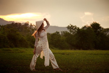blonde girl closeup in Vietnamese looks into distance on field