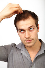 Fototapeta premium Hair loss concept - young man worried about baldness