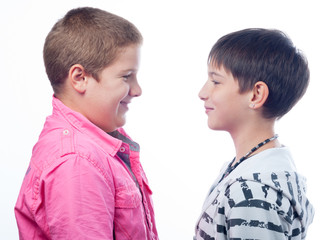 Two teenage boys smiling at each other 