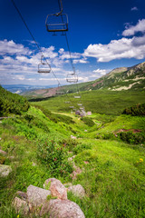 Fototapeta premium Aerial lifts above the valley in the mountains