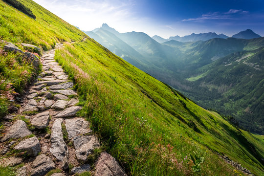 Footpath in the mountains at sunrise