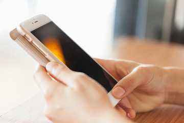 Hand is playing a smart phone.