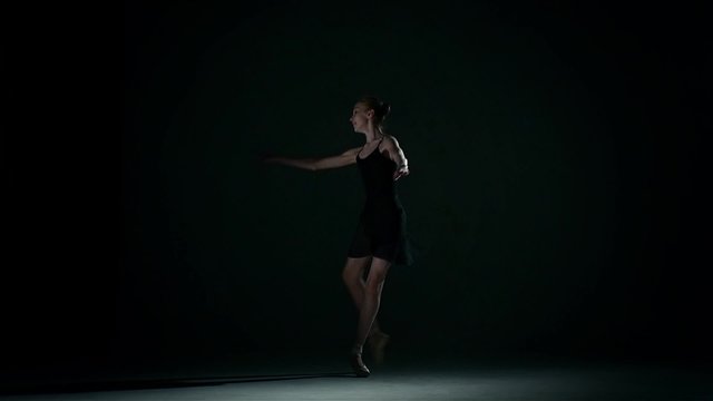  ballerina in the ballet hall on black. slow motion