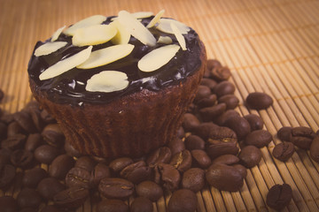 Vintage photo, Chocolate muffins with sliced almonds and coffee grains