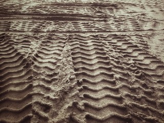 Wheel tracks on the soil.